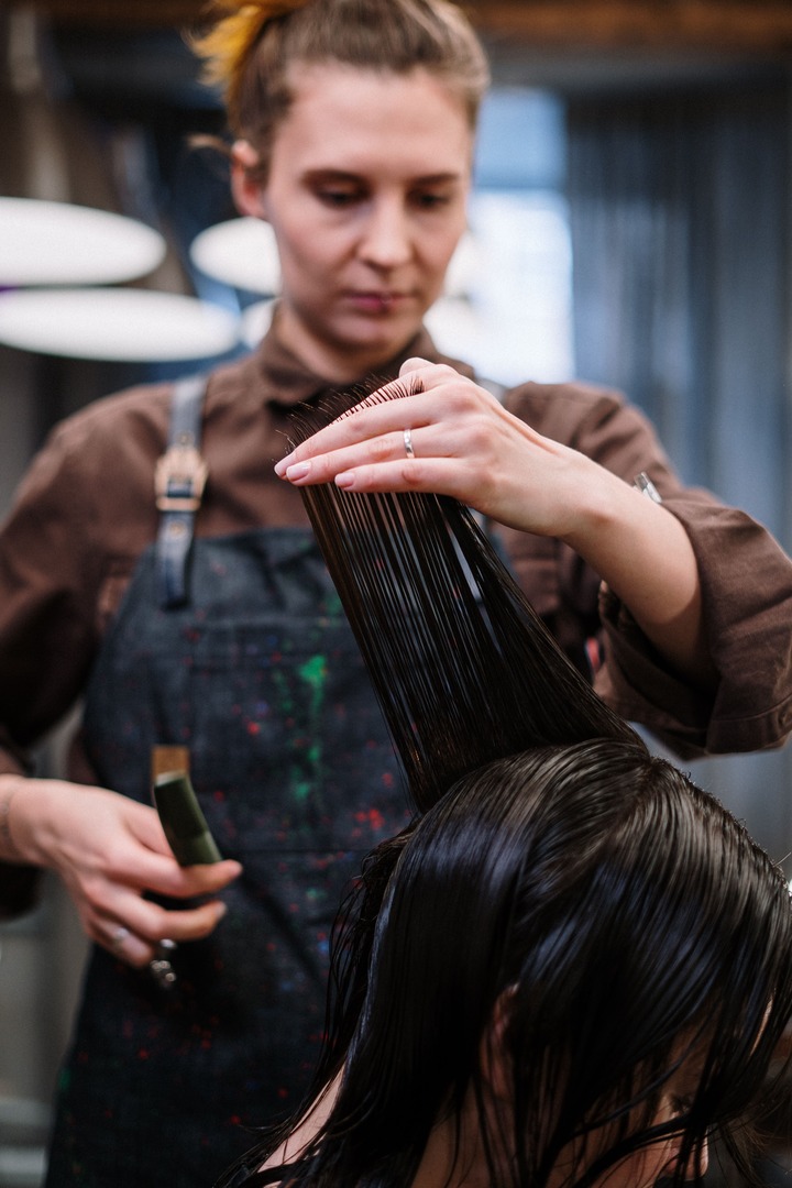 Stylist at work at Ankon Beauty Saloon in Ozone Park, NY
